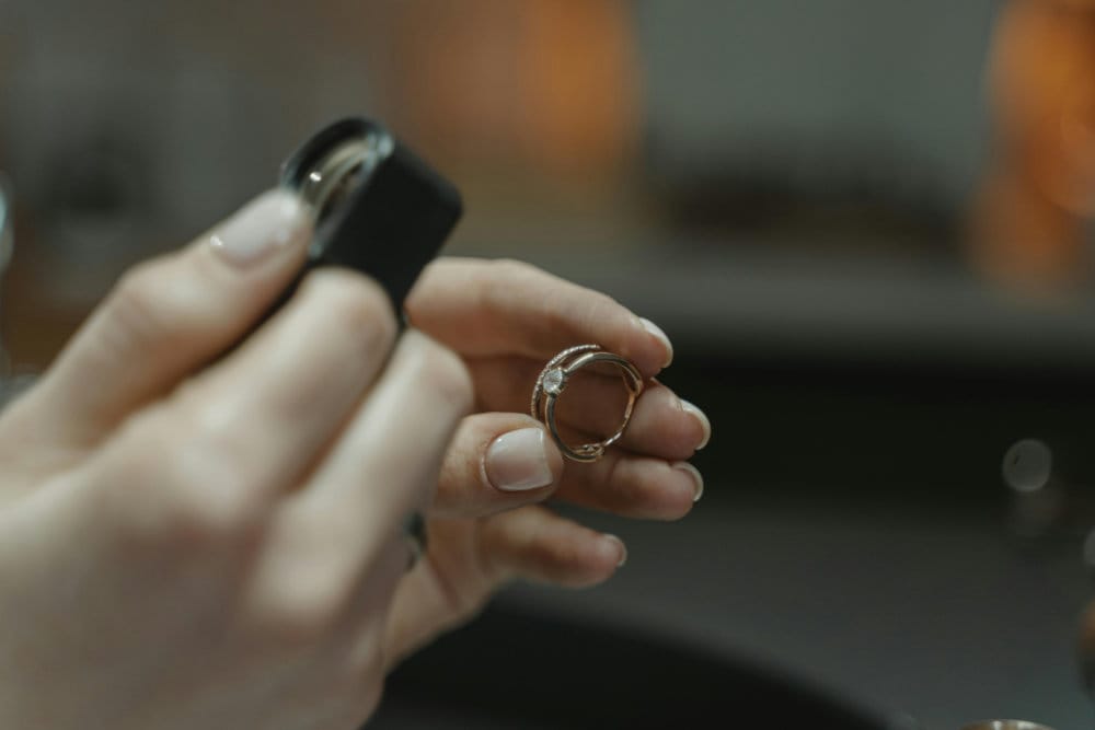 A jewellery maker looking at a ring through a loupe