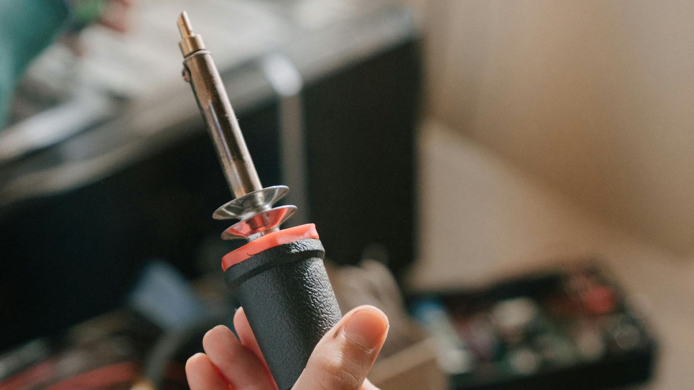 A soldering iron being wielded