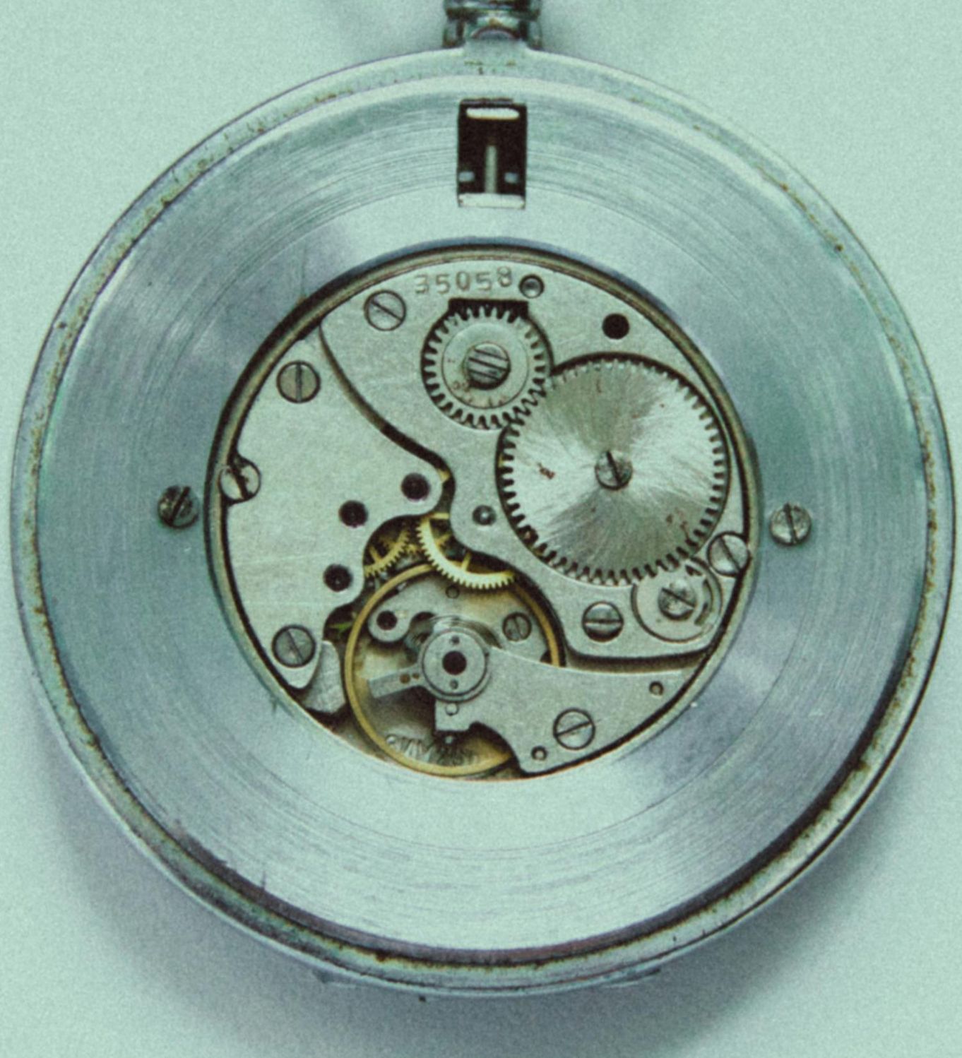 An open watch back showing the clockwork inside