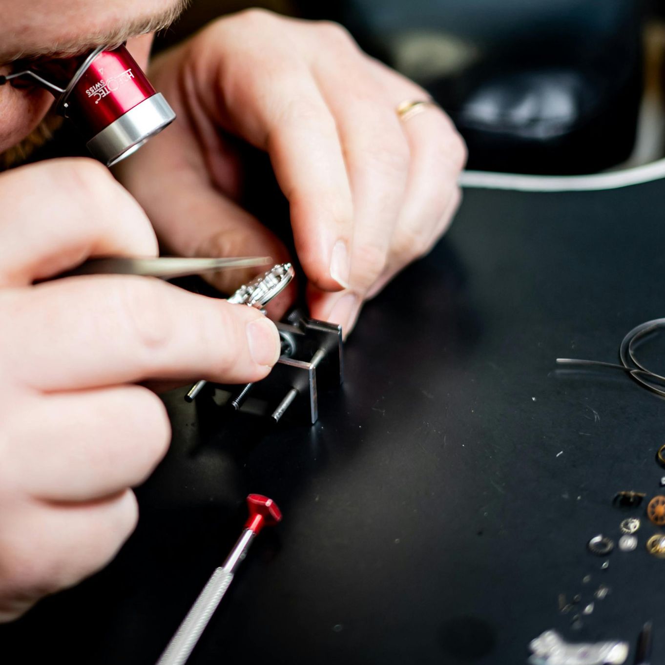 Watchmaker using magnifying loupe.jpg